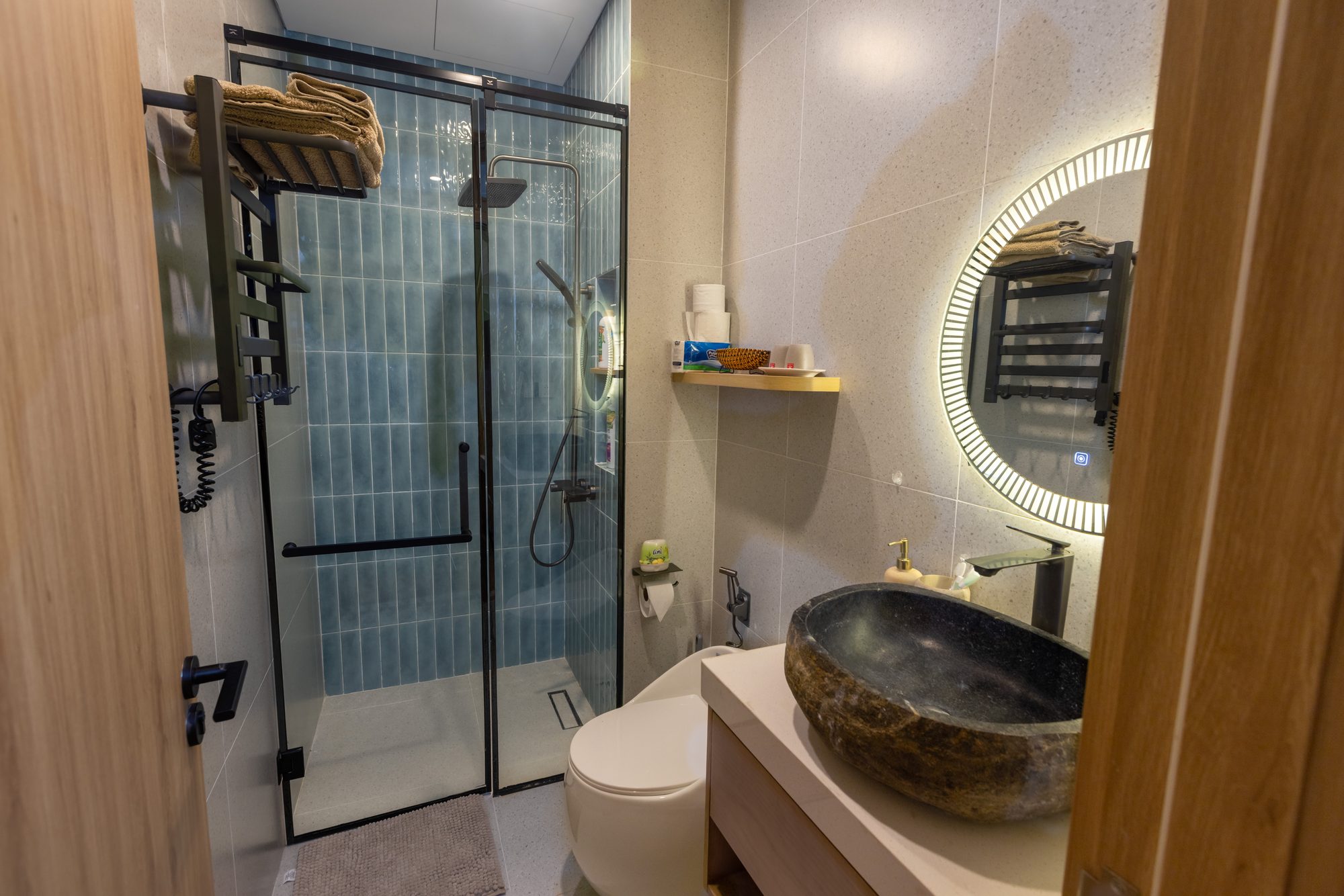 Bathroom with blue tile shower
