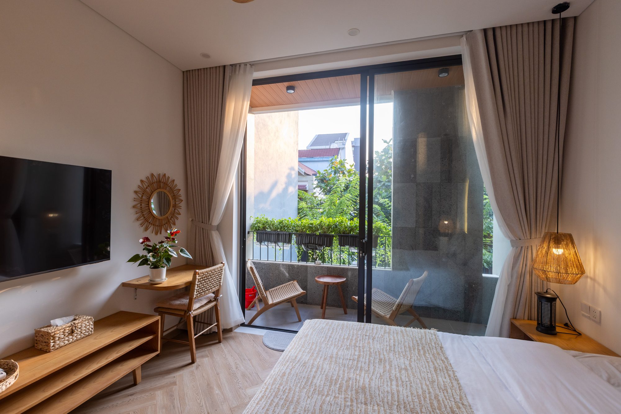 Bedroom with TV and balcony