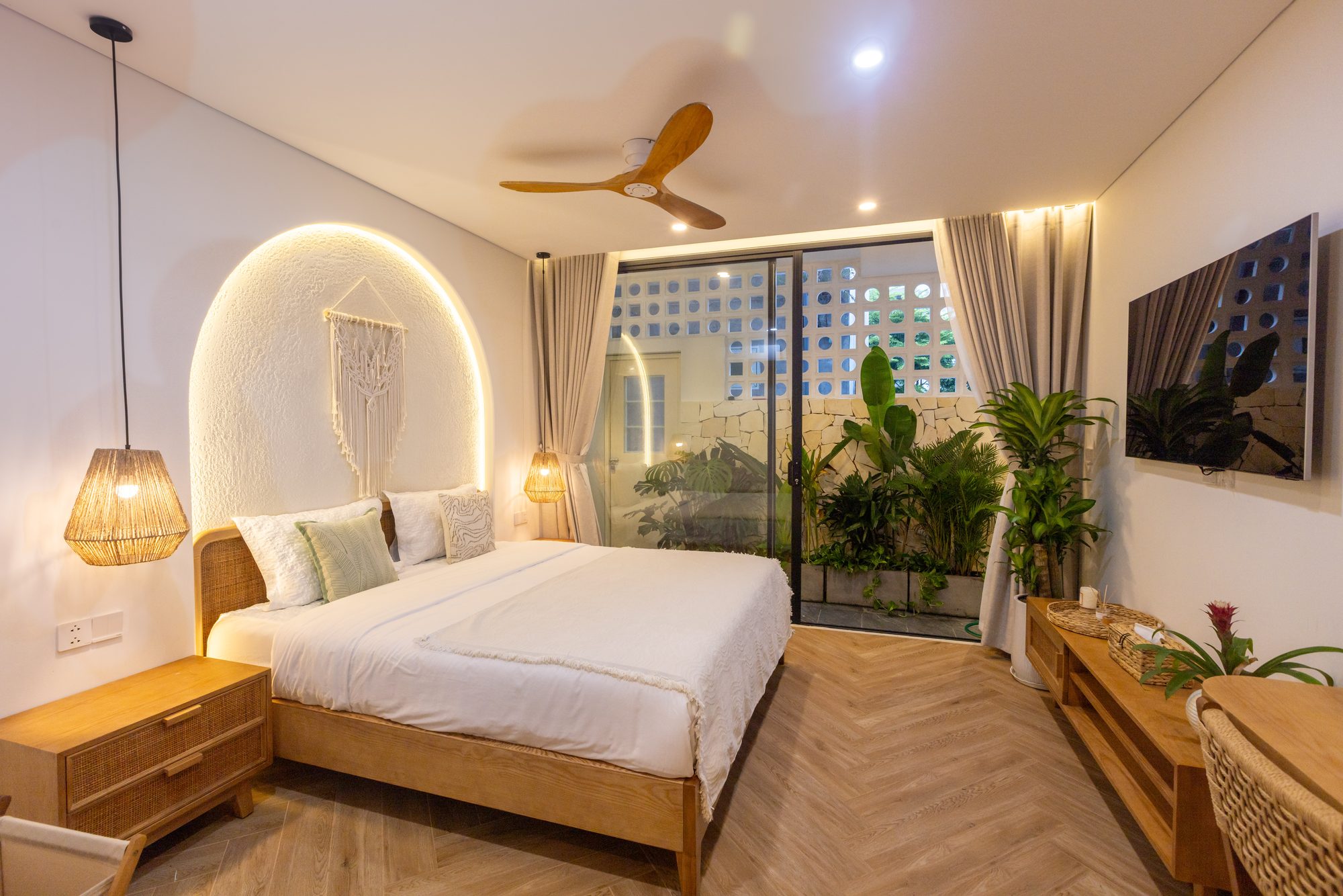 Bedroom with stone arch and balcony